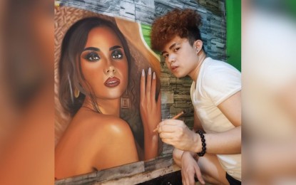 <p><strong>PORTRAITS.</strong> Gary Bonguit poses with his portrait artwork of Miss Universe 2018 Catriona Gray. Bonguit is now earning from commissioning artworks in this time of pandemic. <em>(Photo courtesy of Gary Bonguit)</em></p>