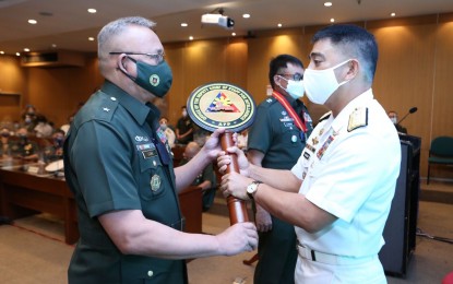 <p><strong>NEW AFP INTEL CHIEF.</strong> New Armed Forces of the Philippines Deputy Chief of Staff for Intelligence, Brig. Gen. Alex Luna (left) accepts his office's official symbol from AFP Deputy Chief of Staff, Rear Admiral Erick Kagaoan (right), in a ceremony held in Camp Aguinaldo, Quezon City on Friday (Oct. 16, 2020). Luna, formerly chief of the Joint Task Force - NCR, replaced Maj. Gen. Greg Almerol who was appointed as commander of the Tanay, Rizal-based 2nd Infantry Division. <em>(Photo courtesy of AFP Public Affairs Office)</em></p>