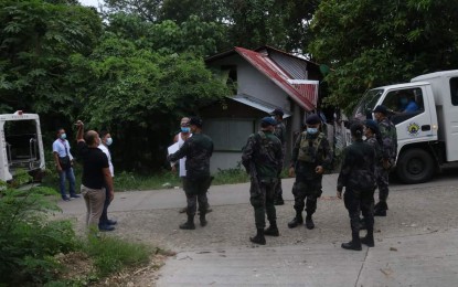 <p><strong>LOCKDOWN.</strong> Local police enforce quarantine measures in a village in Maasin City under lockdown in this undated photo. The city government here on Thursday (Oct. 15, 2020) placed five villages under enhanced community quarantine (ECQ) due to rising cases of coronavirus disease 2019. <em>(Photo courtesy of Maasin City government)</em></p>