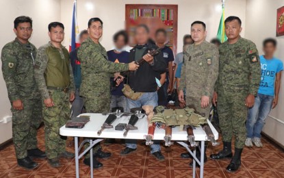 <p><strong>ASG SURRENDERERS.</strong> An Abu Sayyaf Group surrenderer hands over a high-power rifle to Col. Antonio Bautista Jr. (3rd from left), commander of the Army's 1101st Infantry Brigade, during the surrender ceremony in Sulu on Friday (Oct. 17, 2020). A total of 11 bandits surrendered to the military to avail of the government’s social integration program. <em>(Photo courtesy of the 11th Infantry Division)</em></p>