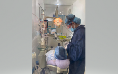 <p><strong>GLIMPSE OF NEW NORMAL.</strong> Dentist Anna Jeanine Ferrer, wearing full personal protective equipment, works on a patient in her clinic. She said the Philippine Dental Association guidelines prompted dentists not to accept walk-in patients for now and instead used telemedicine services to screen patients and set a schedule. <em>(Photo courtesy of Dr. Ferrer)</em></p>