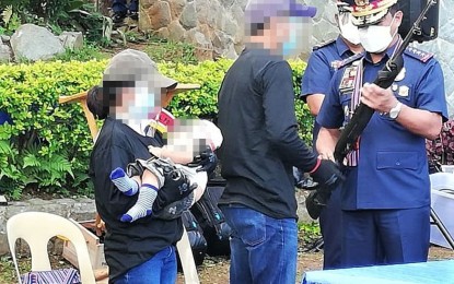 <p><strong>OATH OF ALLEGIANCE</strong>. "Michael” and “Gian”, a couple who established a family while on the mountains fighting against the government, recited their oath of allegiance administered by Philippine National Police chief, Gen. Camilo Pancratius Cascolan, on Monday (Oct. 19, 2020) at Camp Dangwa in La Trinidad, Benguet. The two surrendered to be able to give their eight-month-old son a better future. (<em>PNA photo by Liza T. Agoot</em>) </p>