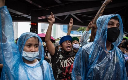 <p><strong>CALL FOR REFORMS.</strong> Pro-democracy protesters wearing raincoats hold up a three-finger salute during an anti-government demonstration in Bangkok, Thailand on October 16, 2020. Thousands of pro-democracy protesters took the streets at Pathumwan Intersection in the center of the Thai capital demanding the resignation of Thailand's Prime Minister and the reform of the monarchy following a "severe state of emergency" declared by Prime Minister Prayut Chan-o-cha. <em>(Anadolu photo)</em></p>