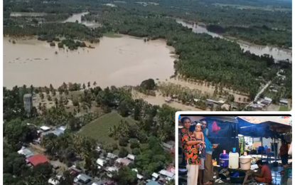 <p><strong>SUBMERGED.</strong> The aerial image of the flooded areas of Pagalungan, Maguindanao as of Tuesday (Oct. 20, 2020). With 11 of 12 barangays flooded, villagers (inset) evacuate and set up temporary shelters along the Cotabato-Davao highway traversing the area while waiting for the floodwaters to recede. <em>(Photo courtesy of Ferdinandh Cabrera – Cotabato Media Group)</em></p>