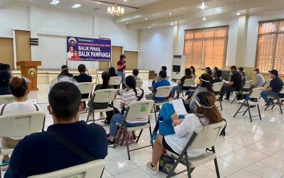 <p><strong>REPATRIATED KAPAMPANGANS</strong>. Angelina Blanco, chief implementer of the "Balik Pinas, Balik Pampanga" program, delivers her message to 17 returning overseas Filipinos during a send-off ceremony in the City of San Fernando, Pampanga on Wednesday (Oct. 21, 2020). A total of 1,505 returning overseas Kapampangans have so far benefited from the program since it was launched by the provincial government last June 30. <em>(Photo by the provincial government of Pampanga)</em></p>