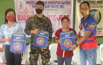 <p><strong>SUPPORT TO TRIBAL SCHOOL.</strong> Tribal school teachers in the Surigao del Sur town of Marihatag receive the more than 100 school bags from the GMA Kapuso Foundation that were formally handed over by 1Lt. Krisjuper Andreo J. Punsalan (2nd from left), the civil-military operations officer of the Army's 3rd Special Forces Battalion, and Nilson D. Malasarte (right), the president of Andap Valley Eagles’ Club. The school is among the two learning facilities constructed by the Army’s 544th Engineer Construction Battalion for the indigenous peoples in the province. <em>(Photo courtesy of 3SFBn)</em></p>