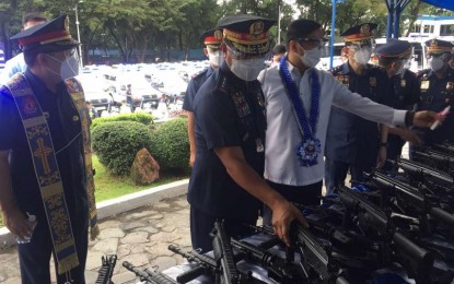 <p><strong>NEW EQUIPMENT.</strong> PNP chief, Gen. Camilo Cascolan, takes a look at one of the new basic assault rifles that are among the PHP569 million worth of new equipment acquired by the police force, in Camp Crame on Monday (Oct. 26, 2020). The new equipment also includes police patrol vehicles, four-wheel-drive troop carriers, motorcycles, and handheld radio transceivers. <em>(PNA photo by Lloyd Caliwan)</em></p>