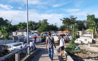 <p><strong>EARLY VISIT.</strong> Residents of Tanauan in Leyte visit their departed family members and relatives at the town's public cemetery in San Miguel village on Wednesday (Oct. 28, 2020). Cemeteries, memorial parks and columbariums in the country would be closed from Oct. 29 to Nov. 4 in compliance with Resolution No. 72 issued by the Inter-Agency Task Force for the Management of Emerging Infectious Diseases, regulating all 'Undas'-related activities amid the coronavirus disease pandemic. <em>(PNA photo by Gerico A. Sabalza)</em></p>