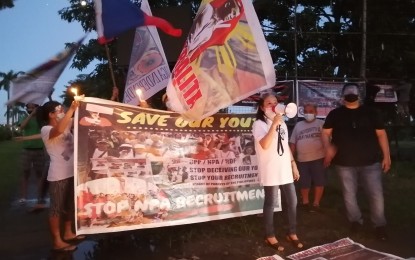 <p><strong>'SAVE OUR YOUTH'.</strong> Anti-communist groups and other civil society organizations gather at the University of the Philippines Diliman on Thursday (Oct. 29) to hold candle-lighting vigils for the victims of the CPP-NPA-NDF. The groups also called for the end of the recruitment of minors by the communist armed movement. <em>(PNA photo by Lade Kabagani)</em></p>