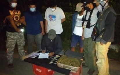 <p><strong>BUSTED.</strong> Police operatives arrest Engr. Benigno Segovia Jr., 30, (3rd from left), an employee of Maritime Industry Authority, and his friend, Emanuel Shun, 27 (2nd from left) in a buy-bust operation early Friday (Oct. 30, 2020) in Zamboanga City. The two allegedly served as resellers of a Sulu businessman who was also arrested in possession of some PHP2.3 million worth of marijuana on Oct. 17 this year. <em>(Photo courtesy of Zamboanga City Police Office's Station 7)</em></p>