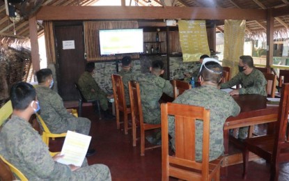 <p><strong>MONITORING</strong>. Members of the Philippine Army's 91st Infantry Battalion, monitor the weather forecast to keep them updated with the situation. They assured the public that they are prepared to assist and respond to calamity especially in areas expected to be battered by Typhoon "Rolly". (<em>Photo courtesy of the Army's 91st Infantry Battalion</em>) </p>