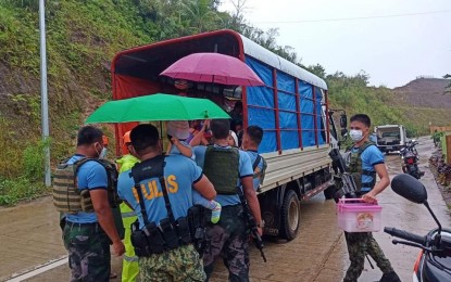 <p><strong>EVACUATION.</strong> Police officers assist in the evacuation of residents living in high-risk areas in Viga, Catanduanes on Saturday (Oct. 31, 2020). Typhoon "Rolly" is expected to bring gusty winds and intense rains as it passes through Catanduanes-Camarines provinces on Sunday morning. (<em>Photo courtesy of Viga police Station FB page</em>) </p>