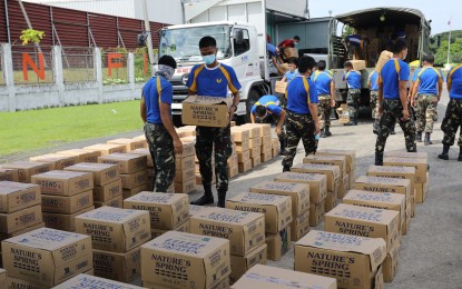<p><strong>RELIEF FOR CATANDUANES.</strong> Philippine Air Force troops organize boxes containing relief supplies for victims of Super Typhoon Rolly in Catanduanes on Tuesday (Nov. 3, 2020). The relief supplies included bottled water, assorted goods, food packs, and personal protective equipment sets from government agencies and an NGO. <em>(Photo courtesy of Air Force Public Affairs Office)</em></p>