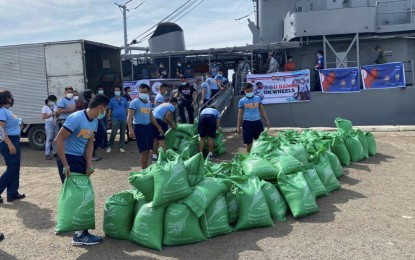 <p><strong>RICE FOR TYPHOON VICTIMS</strong>. Personnel of the Philippine National Police in Central Visayas load 500 sacks of rice to a Philippine Coast Guard vessel on Wednesday (Nov. 4, 2020). Police Regional Office-7 chief Brig. Gen. Albert Ignatius Ferro said the sacks of rice will be donated to the victims of Super Typhoon Rolly in the Bicol Region.<em> (Photo courtesy of OPAV)</em></p>