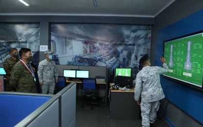 <p><strong>SUPPORT FOR NSSC.</strong> AFP chief-of-staff Gen. Gilbert Gapay (left) takes a tour of the Naval Sea Systems Command units in Cavite City on Wednesday (Nov. 4, 2020). During the tour, the NSSC showcased cutting-edge technologies in the fields of weaponry, electronic communications, virtual and augmented reality, virtual training, and education. <em>(Photo courtesy of the AFP Public Affairs Office)</em></p>