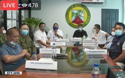 <p><strong>HELP FOR CATANDUANES.</strong> Presidential Spokesperson Harry Roque (holding microphone) assures more help for typhoon-ravaged Catanduanes from the national government during a press briefing in the province on Thursday (Nov. 5, 2020). With him are Governor Joseph Cua (at Roque's left) and other provincial officials.<em> (Screenshot of the briefing from PTV-4 video)</em></p>