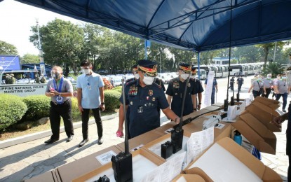 <p><strong>NEW EQUIPMENT.</strong> PNP chief, Gen. Camilo Cascolan (center) takes a look at the PHP1.2 billion worth of new equipment for PNP units in a ceremony in Camp Crame on Friday (Nov. 6, 2020). These include shuttle buses, high-speed tactical watercraft, patrol jeep single cabs, 5.56mm basic assault rifles, and VHF low band handheld radios. <em>(Photo courtesy of PNP PIO)</em></p>
