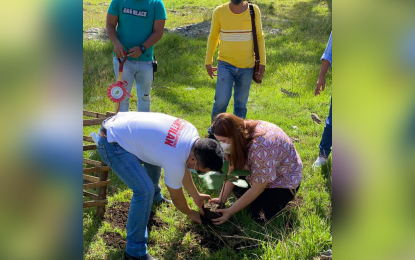 <p><strong>A MILLION TREES.</strong> Mayor Carla Lopez-Pichay (sitting, right) of Cantilan town in Surigao del Sur leads the launching of the greening program in the area on Monday (Nov. 9, 2020) that seeks to plant around 1.3 million trees by 2021. The massive tree planting initiative is part of the 'cash for work' program of the municipality. <em>(Photo courtesy of the local government of Cantilan)</em></p>