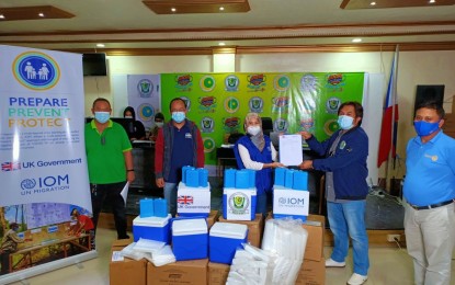 <p><strong>VIRUS SPECIMEN MANAGEMENT.</strong> Health officials and representatives from the International Organization for Migration show the deed of donation for effective handling of coronavirus disease 2019 specimen in the Bangsamoro Region in Muslim Mindanao. The International Organization for Migration (IOM) donated over 240 specimen carriers, 240 ice packs, and 4,800 specimen bags to the regional government on Monday (Nov. 9, 2020)<em>. (Photo courtesy of MOH-BARMM)</em></p>