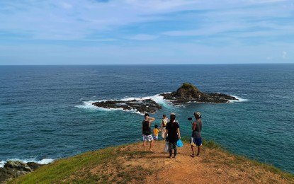 <p><strong>‘LITTLE BATANES’.</strong> Tourists flock to the hill facing the Bagbag Beach in Sual town in Pangasinan to get a photo at the “Little Batanes of Pangasinan” after it went viral on social media. The tourist spot is now gaining more visitors but is currently open only for residents of the Ilocos Region.<em> (Photo by Hilda Austria)</em></p>
