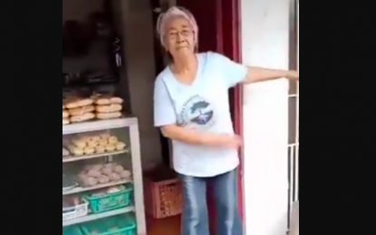 <p><strong>POSITIVITY.</strong> Paulina Serrano or ‘Inay Nena’, 80-year old of Maguihan, Lemery, Batangas dances in front of her bakeshop. She said neither a pandemic nor a disaster can shake her positive outlook in life. <em>(Photo grabbed from Beleth Serrano Aquino FB page)</em></p>