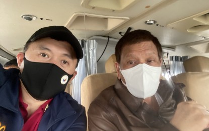 <p><strong>AERIAL INSPECTION</strong>. Senator Christopher Lawrence "Bong" Go poses for a selfie with President Rodrigo Duterte inside a helicopter during an aerial inspection of areas struck by Typhoon Ulysses on Thursday (Nov. 12, 2020). Duterte inspected the damage in Marikina City and Rizal province. <em>(Photo courtesy of Senator Bong Go)</em></p>