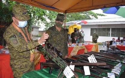 <p><strong>RIGHT DECISION.</strong> Maj. Gen. Juvymax Uy (left), commander of the Army’s 6th Infantry Division, checks one of the rifles that Bangsamoro Islamic Freedom Fighters surrenderers turned in to the Army in Maguindanao on Friday (Nov. 13, 2020) as Army 33rd Infantry Battalion commander, Lt. Col. Elmer Boongaling looks on. Uy said the rebels made the right decision to peacefully surrender and live normal lives. <em>(Photo courtesy of 6ID)</em></p>