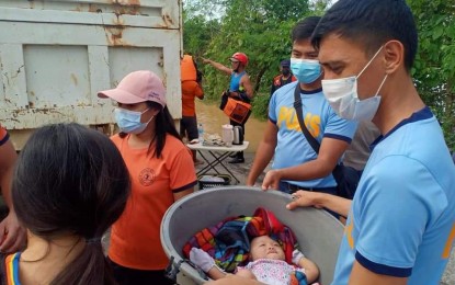 <p><strong>TO THE RESCUE.</strong> A baby is among those rescued by police personnel in Barangay Linao Norte, Tuguegarao City, Cagayan on Friday (Nov. 13, 2020) after Typhoon Ulysses caused massive floods in the province. The DILG said some 3,267 police and fire personnel were deployed to conduct search and rescue operations in flood-hit areas in Cagayan Valley. <em>(Photo courtesy of Tuguegarao City PNP)</em></p>