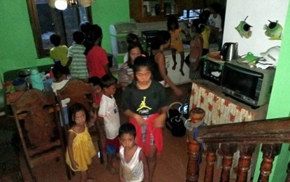 <p><strong>OPEN DOORS</strong>. Families take shelter in a private house in Barangay Binanuahan, Bato town in Catanduanes during the onslaught of Super Typhoon Rolly last Nov. 1. Governor Joseph Cua said families residing in concrete and sturdy houses offer shelter and food to their neighbors whose houses cannot withstand strong winds and heavy rains during typhoons. <em>(Photo courtesy of Salve Traqueña)</em></p>