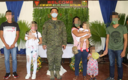 <p><strong>FAMILY TIES</strong>. Lt. Col. Erwin Cariño (center), commander of the Philippine Army’s 15th Infantry Battalion, with former rebels Ritchell Oray (2nd from left) and Albert Yanong (right) with their children and spouses. The troops served as godparents during the children's baptism rites held during the unit’s 47th founding anniversary at their headquarters in Cauayan, Negros Occidental on Friday (Nov. 13, 2020). <em>(Photo courtesy of the 15th Infantry Battalion, Philippine Army)</em></p>