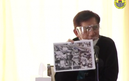 <p><strong>FLOOD PREVENTION.</strong> DENR Secretary Roy Cimatu shows a 1988 map of Cebu City which showed the blue line representing the downflow of a creek in Barangay Camputhaw. Cimatu on Monday (Nov. 16, 2020) pressed the Cebu City government to clear the creeks, rivers, estuaries and other waterways of structures that violated the three-meter easement as a measure to mitigate flooding during heavy downpour.<em> (Screengrab from Cebu City Hall PIO video)</em></p>
