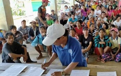 <p><strong>UNWELCOME.</strong> Officials and residents of Barangays Pange and Macasing take turn in signing the resolution declaring New People's Army rebels as persona non grata on Sunday (Nov. 22, 2020). The two villages have long been under the influence of the rebels, officials say. <em>(Photo courtesy of 53IB)</em></p>