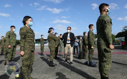<p><strong>MEDICAL TEAM.</strong> National Task Force on Covid-19 chief implementer Secretary Carlito Galvez Jr. (center) greets the members of the AFP medical team in a sendoff ceremony at the Villamor Air Base in Pasay City on Monday (Nov. 23, 2020). The contingent, composed of military doctors and nurses, and medical aides from the AFP Health Service Command, Philippine Army, Philippine Navy, and the Philippine Air Force, was deployed to Davao City to help address the rising number of Covid-19 cases in the city. <em>(Photo courtesy of AFP Public Affairs Office)</em></p>