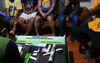 <p><strong>BUSTED</strong>. An operative of the Philippine Drug Enforcement Agency (PDEA) accounts for the pieces of evidence gathered from a buy-bust at Lasip Grande Dagupan City on Nov. 26, 2020. The PDEA, together with the police, arrested five persons and dismantled a drug den in the operation.<em> (Photo courtesy of Alexander James Navarro of Aksyon Radyo Pangasinan)</em></p>
