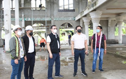 <p><strong>MARAWI REHAB</strong>. Task Force Bangon Marawi (TFBM) Chairperson and housing czar Secretary Eduardo del Rosario (center) leads an ocular inspection of the ongoing reconstruction of a mosque in Marawi City on Nov. 27, 2020.  He said the rehabilitation of the mosques is significant to the social healing and recovery of the conflict-affected Maranaos. <em> (Contributed photo from TFBM)</em></p>