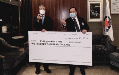 <p><strong>SOKOR DONATION</strong>. Philippine Red Cross chairman and CEO, Senator Richard Gordon (right) receives a check for USD200,000 from outgoing South Korean Ambassador to the Philippines Han Dong Man during a dinner on Nov. 23, 2020. Gordon thanked the Korean government for nearly PHP10 million humanitarian assistance for victims of Super Typhoon Rolly and Typhoon Ulysses. <em>(Philippine Red Cross photo)</em></p>