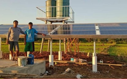 <p><strong>SOLAR-POWERED</strong>. Noli Bergonia (right), president of the Rang-Ay Upland Integrated Farmers Association Inc. (RUFAI) of Bani town in Pangasinan, and landowner Albert Horada (left) pose in front of the solar-powered irrigation system at Barangay Dacap Norte. The project is under the Climate Resilient Farm Productivity Support (CRFPS) project of the Department of Agrarian Reform. <em>(Photo courtesy of DAR Pangasinan)</em></p>