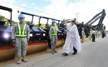 <p><strong>NEW EQUIPMENT.</strong> A chaplain leads the blessing of 57 units of aviation engineering equipment of the Philippine Air Force at the Basa Air Base, Floridablanca, Pampanga on Wednesday (Dec. 2, 2020). The equipment consists of trucks, hydrostatic bulldozers, a compact backhoe loader, equipment haulers, self-loading mixers, excavators, and road rollers.<em> (Photo courtesy of Air Force Public Affairs Office)</em></p>