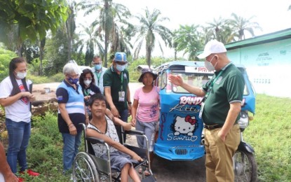 <p><strong>NEW WHEELCHAIR.</strong> Larry Baulite who could hardly walk on his own due to a kidney problem was elated by the gift of the city government through Mayor Angelo Montilla (right) in Tacurong City on Wednesday (Dec. 2, 2020). Baulite, together with 12 other persons with disabilities that included senior citizens, had received wheelchairs and financial aid from the local government. <em>(Photo courtesy of Tacurong CIO)</em></p>