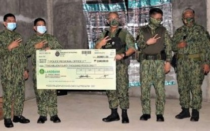 <p><strong>TURN-OVER</strong>. The Police Regional Office in Cordillera (PROCOR) has raised a total of PHP19.2 million from the voluntary donation of policemen assigned in the Cordillera Administrative Region (CAR) intended for various humanitarian aid. PROCOR Director, BGen. R’Win Pagkalinawan (3rd from left), turns over a cheque worth PHP2.04 million to PRO-2 Deputy Regional Director for administration BGen. Edgar Cacayan (2nd from left) on Thursday (Dec. 3) while another PHP1.37 million will, later on, be turned-over to PRO-5. Also present are other key officers of PROCOR and PRO-2. (<em>Photo courtesy of PROCOR-PIO</em>)  </p>