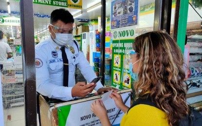 <p><strong>QR CODE SYSTEM</strong>. A security guard of a department store in Borongan City in Eastern Samar scans the QR (quick response) code of a customer in this undated photo. The city government on Friday (Dec. 4, 2020) said it already registered 103,426 names in its QR code system, meant to boost its contact tracing for suspected coronavirus carriers. <em>(Photo courtesy of Borongan City government)</em></p>