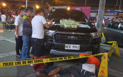 <p><strong>BUY-BUST</strong>. The Philippine National Police-Drug Enforcement Group presents two suspected drug couriers arrested in a buy-bust operation in Parañaque City on Saturday night (Dec. 5, 2020). Authorities also seized eight kilos of “high-grade” shabu with estimated street value of PHP54.4 million and a black Ford Ranger from the suspects. <em>(Photo courtesy of PNP-DEG)</em></p>