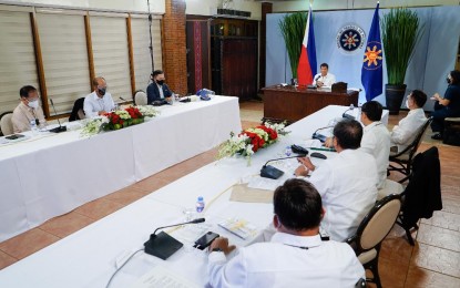 <p><strong>NO KICKBACKS.</strong> President Rodrigo Roa Duterte presides over a meeting with the Inter-Agency Task Force on the Emerging Infectious Diseases (IATF-EID) core members prior to his talk to the people at the Malago Clubhouse in Malacañang Park, Manila on Dec. 7, 2020. Duterte said the purchase of Covid-19 vaccines for Filipinos will be free from kickbacks with vaccine czar Carlito Galvez Jr. in charge. <em>(Presidential photo by King Rodriguez)</em></p>