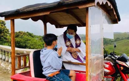 <p><strong>MOBILE CONFESSION</strong>. Fr. Ronaldo Manabat, the parish priest of the Cathedral of the Immaculate Conception in Basco, Batanes, drives his tricycle to bring the Sacrament of Penance to the people's doorsteps amid the Covid-19 pandemic. He said his target are the youth and senior citizens whose mobility are restricted during the community quarantine.<em> (Photo by Leonard Taghap)</em></p>