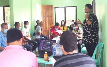 <p><strong>PREPARATIONS.</strong> Las Nieves, Agusan del Norte Mayor Avelina Rosales (standing, right) presides the meeting of stakeholders and farmer leaders in preparation for the start of the construction of the PHP19-million coffee processing center on the first quarter of 2021. The center is seen to boost coffee bean production and trade in the town and the nearby areas in the province. <em>(Photo grab from Agusan UP Facebook Page)</em></p>