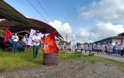 <p><strong>NO TO COMMUNISM.</strong> At least 200 200 former New People’s Army rebels and mass-based supporters participate in a peace rally hours before their three-day peacebuilding seminar in Tulunan, North Cotabato, on Monday (Dec. 21, 2020). The rally participants burned the flag of the Communist Party of the Philippines to signify their rejection of the communist rebel movement.<em> (Photo courtesy of 39IB)</em></p>