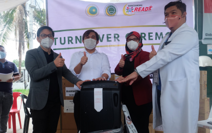 <p><strong>VENTILATORS. </strong>Lawyer Naguib Sinarimbo (left), BARMM minister of the Interior and Local Government, and Dr. Amirel Usman, acting chief of the region's Ministry of Health, lead the turnover of complete sets of two mechanical ventilators for Maguindanao Provincial Hospital and Datu Blah Sinsuat District Hospital in Upi, Maguindanao on Monday (Dec. 21, 2020). The regional government says five other hospitals in the area are set to receive the same medical equipment. <em>(Photo courtesy of BPI-BARMM)</em></p>