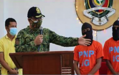 <p><strong>BIFF SURRENDERERS.</strong> Brig. Gen. Samuel Rodriguez Jr. (foreground), BARMM police director, presents to reporters the two BIFF surrenderers during a simple ceremony held at the PRO-BARMM headquarters in Camp S.K. Pendatun, Parang, Maguindanao on Tuesday (Dec. 22, 2020). The two belonged to the BIFF-Karialan faction operating in the Liguasan marshlands of the province. <em>(Photo courtesy of PRO-BARMM)</em></p>