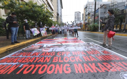 <p><strong>SURRENDER NOW</strong>.  Anti-communist groups and civil society organizations have marched from Morayta Street to the Mendiola Peace Arc in Manila, to protest the CPP-NPA-NDF's commemoration of its 52nd founding anniversary on Saturday (Dec. 26, 2020). The groups also condemn the 52 years of atrocities, killings of innocents, unhampered terror attacks, and relentless recruitment of minors perpetrated by the NPA rebels. (<em>PNA photo by Joey Razon</em>) </p>