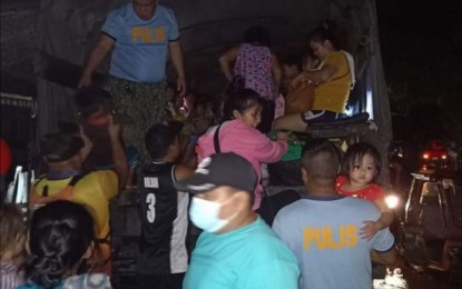 <p><strong>EVACUATION</strong>. Personnel of Victorias City Police Station in Negros Occidental assist residents seeking evacuation after flashfloods hit 12 villages in the northern city early morning on Friday (Jan. 1, 2021). Heavy rains led to flooding in four localities in the province's third district.<em> (Photo courtesy of Victorias City Police Station)</em></p>